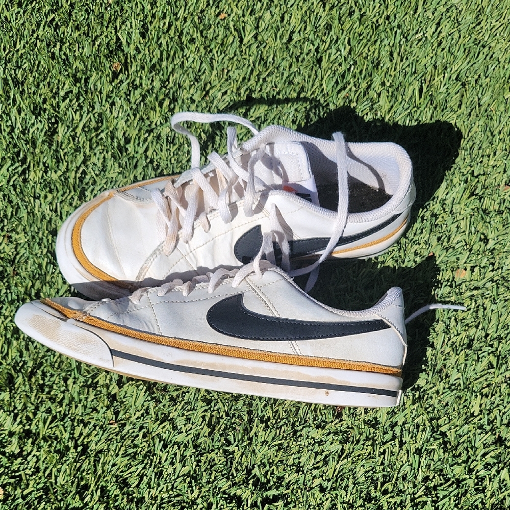 Nike White and Black Sneakers with Gold Accents